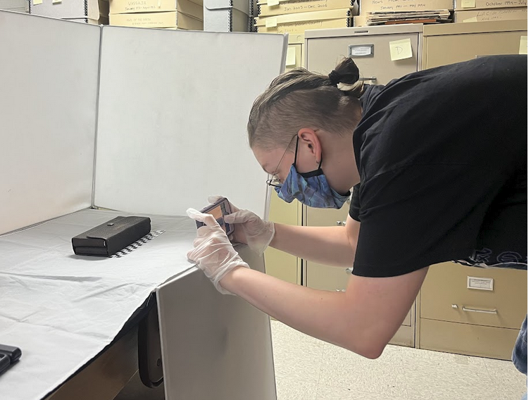Basil taking a photo of a museum artifact